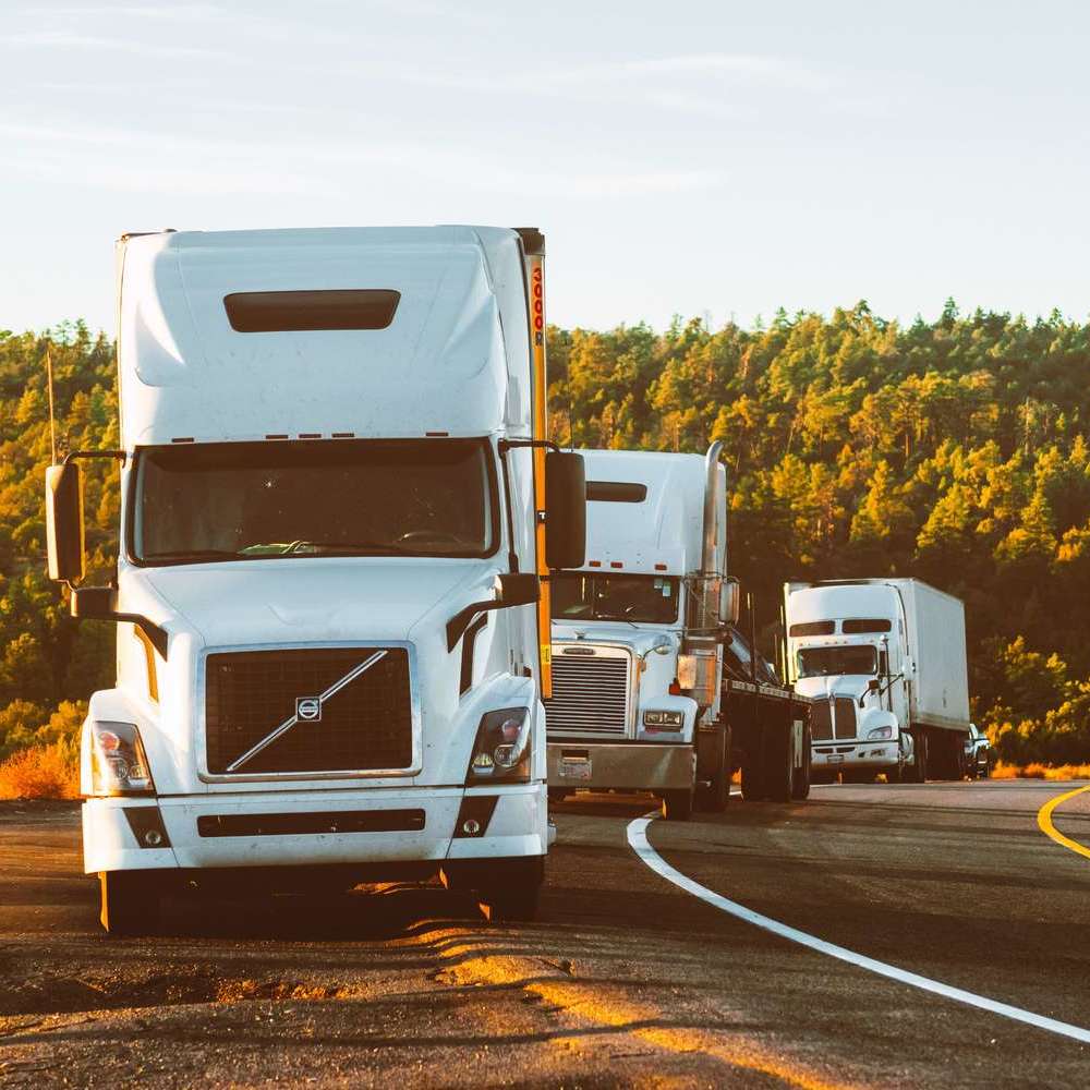 white-volvo-semi-truck-on-side-of-road-2199293.jpg